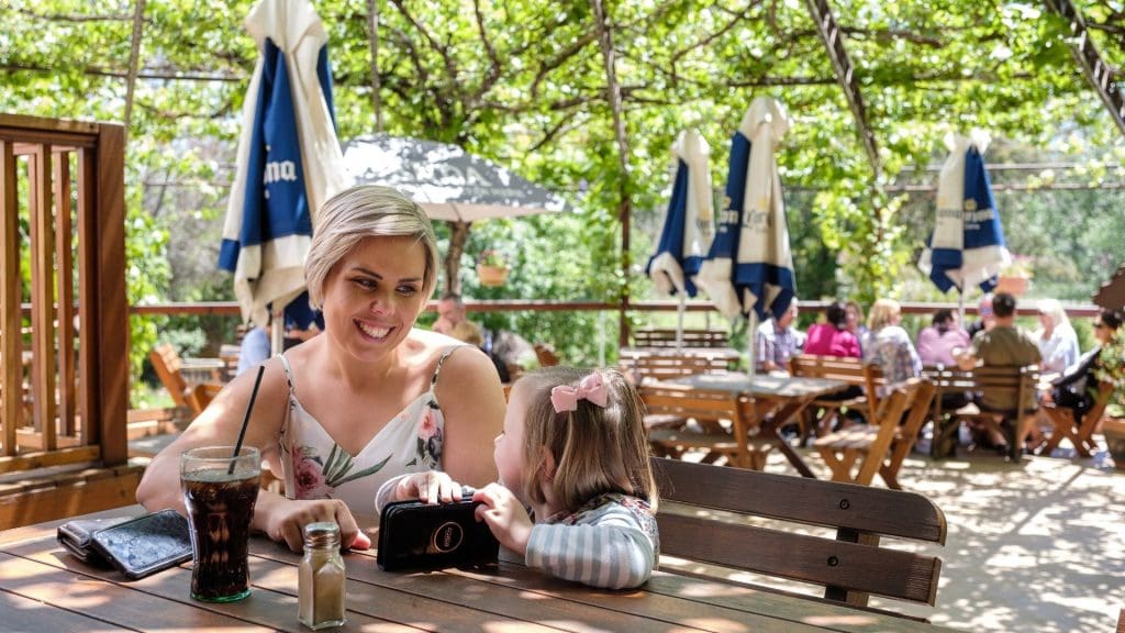 Mother and daughter sitting at a table in the beer garden of the Peel Inn, Nundle