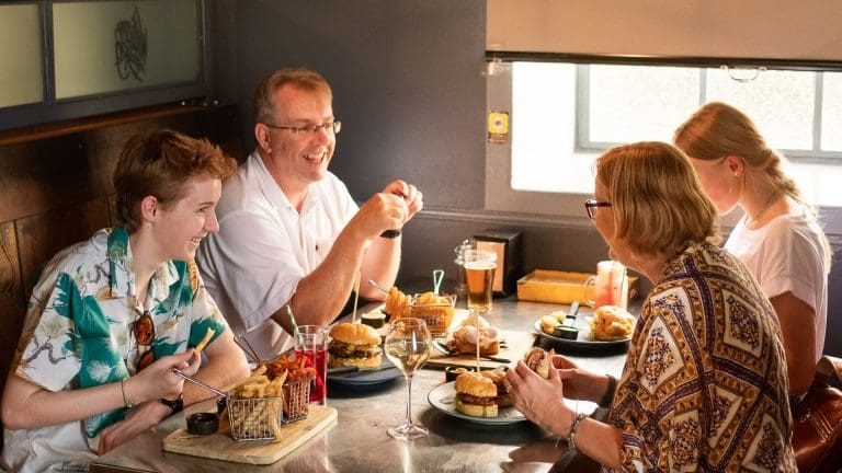 family of four enjoying burgers and fries at Williamsburg Burger Bar Tamworth